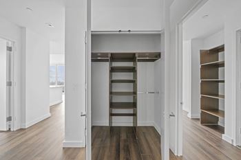 a small loft with a ladder in a white room at SKY Apartments, New York 10036